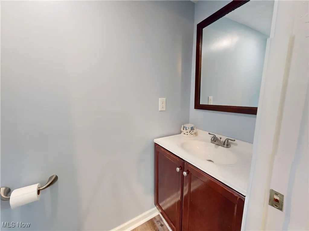 Bathroom featuring vanity and wood finished floors