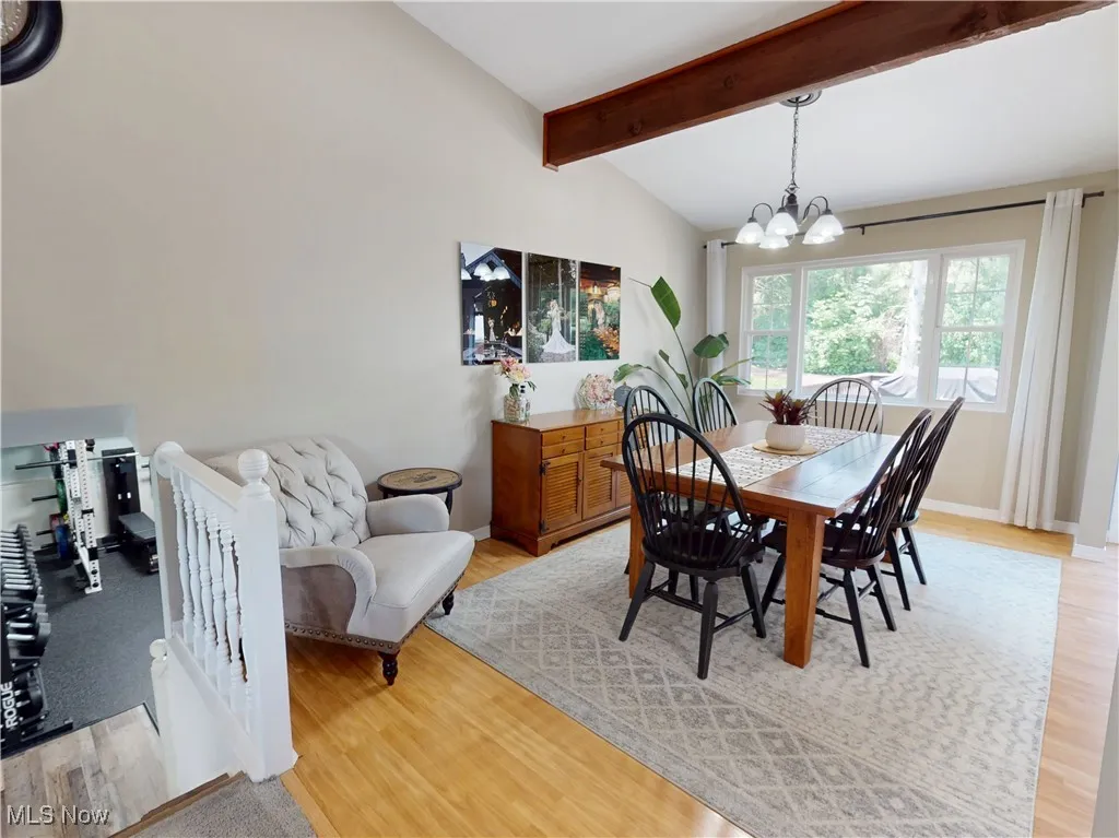 Dining area with a chandelier and light wood finished floors