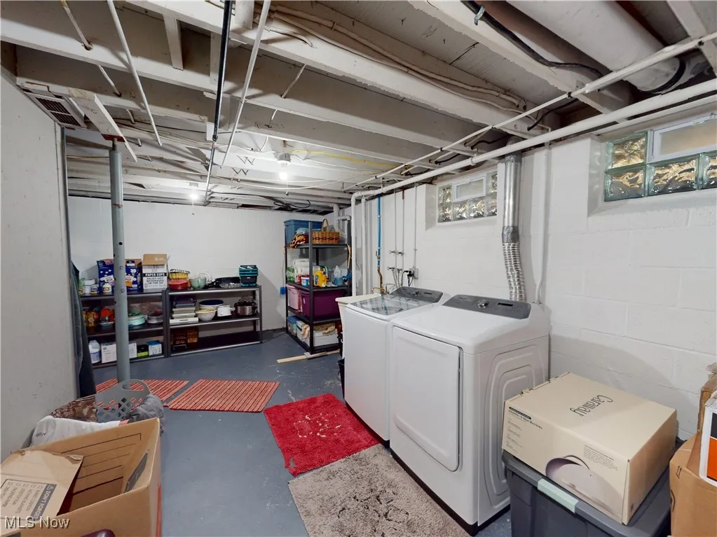Below grade area with washing machine and clothes dryer