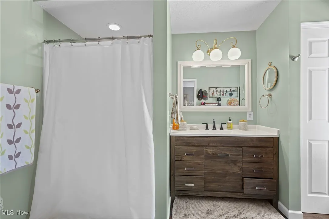 Bathroom with vanity and curtained shower