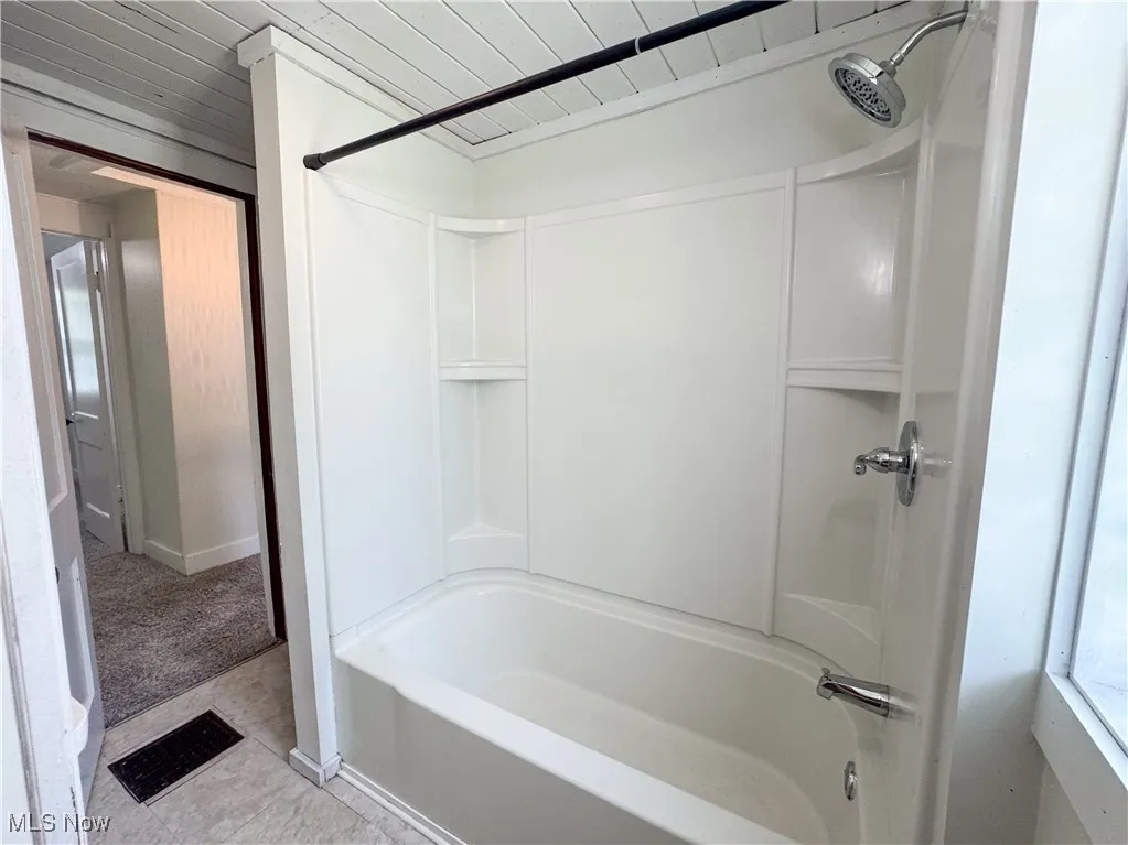 Full bath featuring shower / bath combination, and wooden ceiling