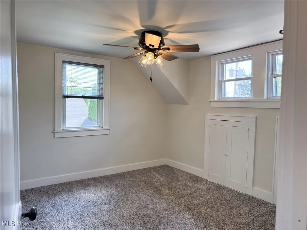 Bedroom featuring ceiling fan, carpet, and healthy amount of natural light