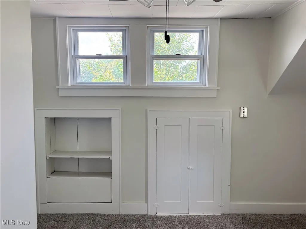 Bedroom with detailed view of carpet floors and baseboards