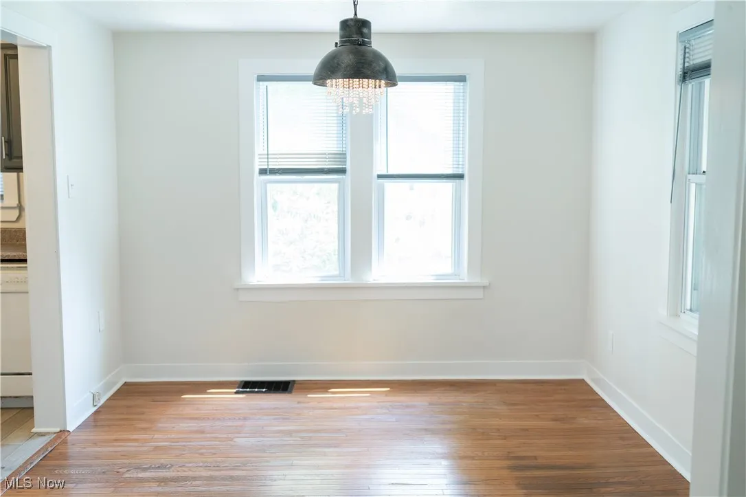 Dining area featuring a chandelier, light wood-style flooring, and plenty of natural light