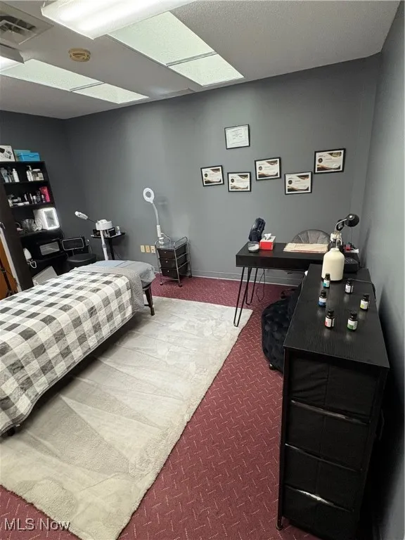 Bedroom featuring carpet flooring and baseboards