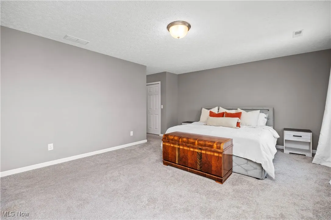 Primary Bedroom with carpeted floor