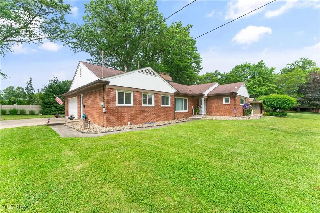 Ranch-style house with brick siding, concrete driveway, and a garage
