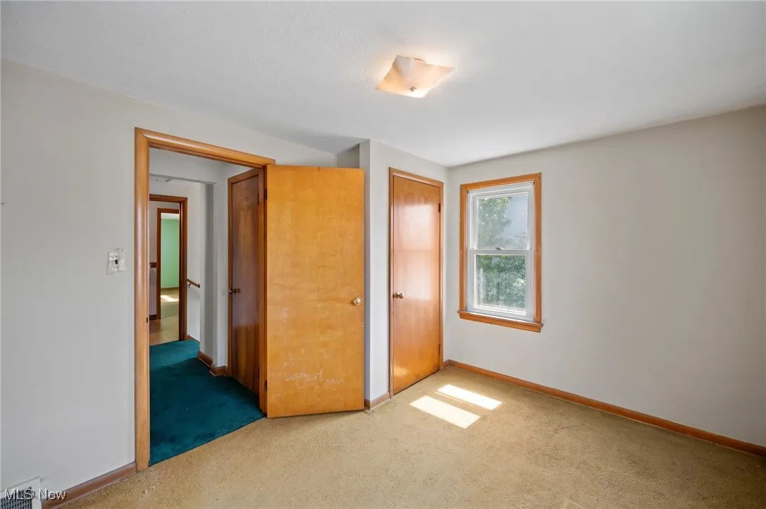 Unfurnished bedroom with carpet and a closet