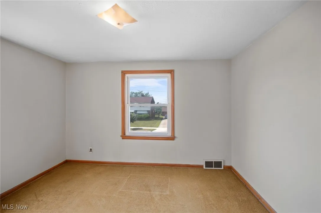 Bedroom with light colored carpet