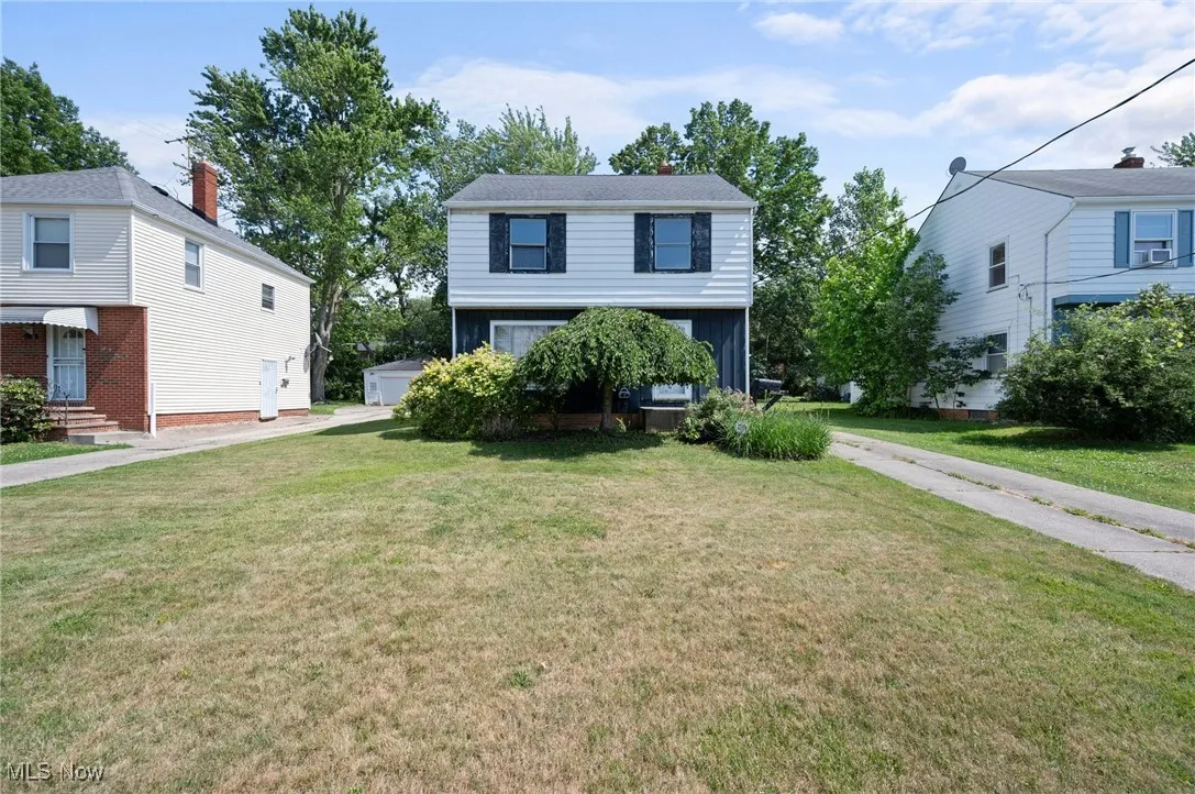 Colonial home with a front yard