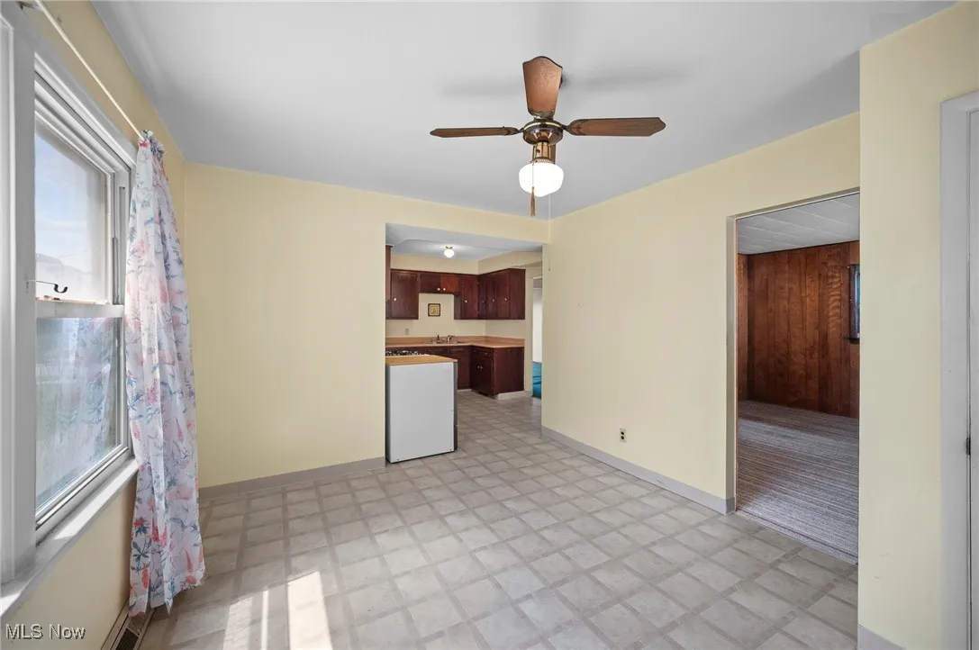 Kitchen eat in area  featuring light flooring and ceiling fan