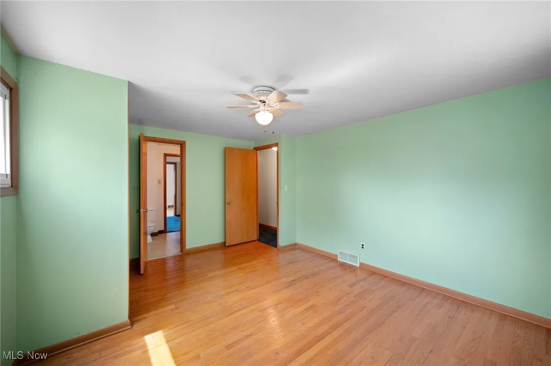 Unfurnished bedroom featuring light wood finished floors and a ceiling fan