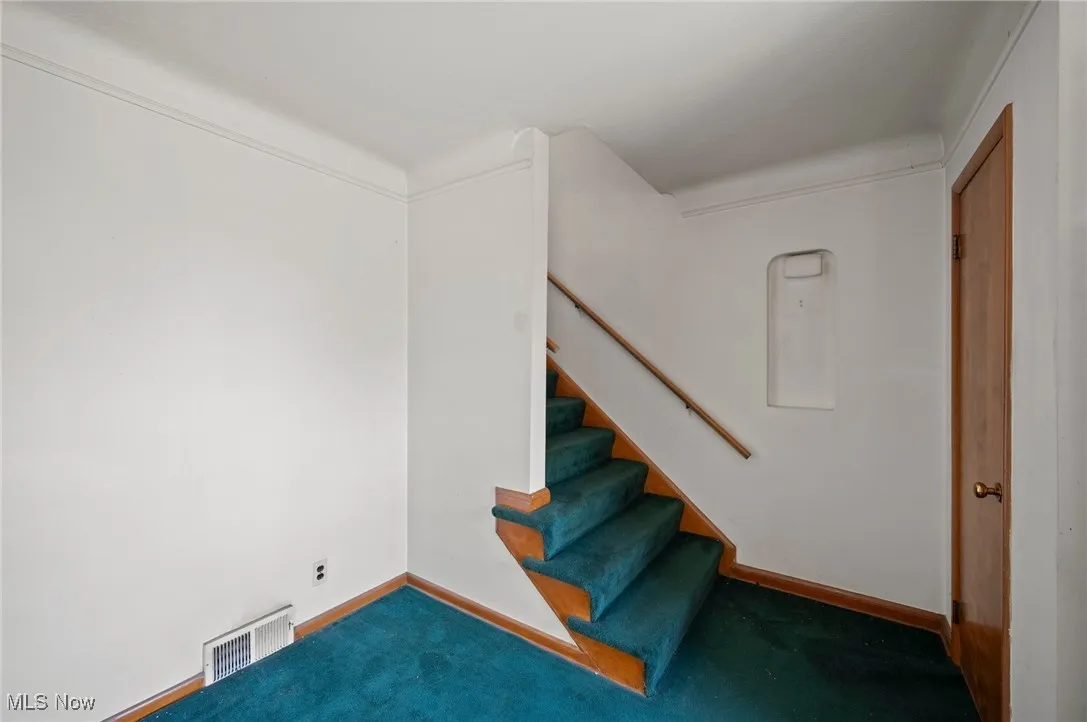 Stairs featuring baseboards and carpet floors