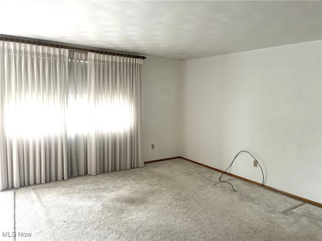 Spare room with carpet flooring and baseboards