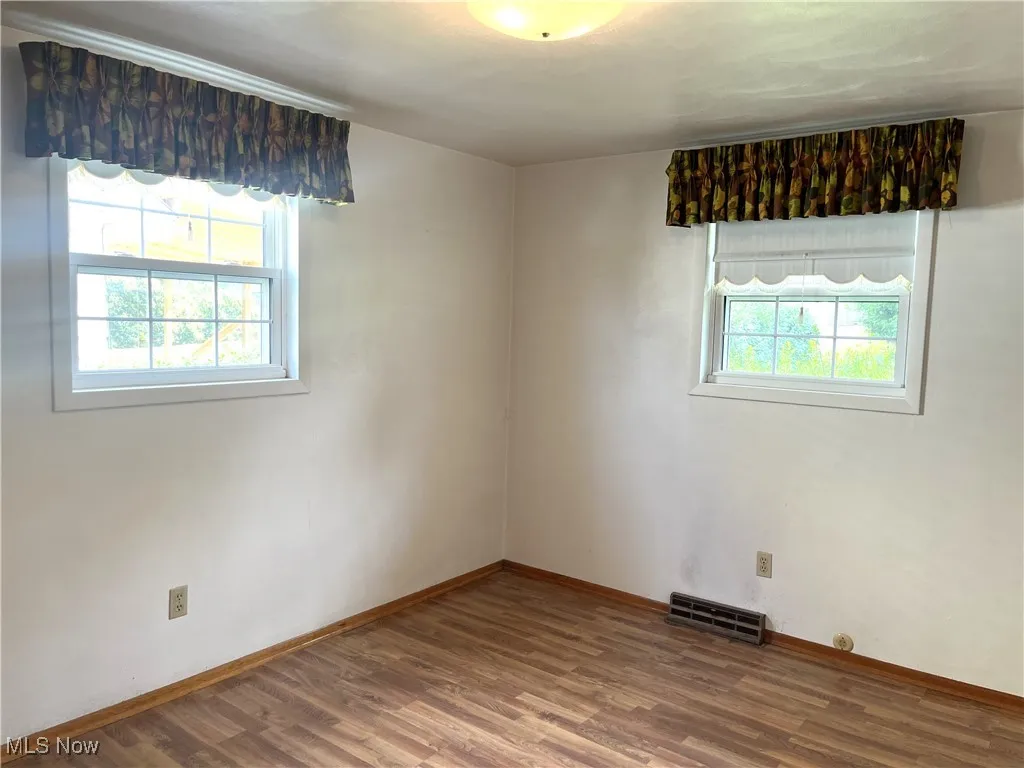 Spare room featuring wood finished floors