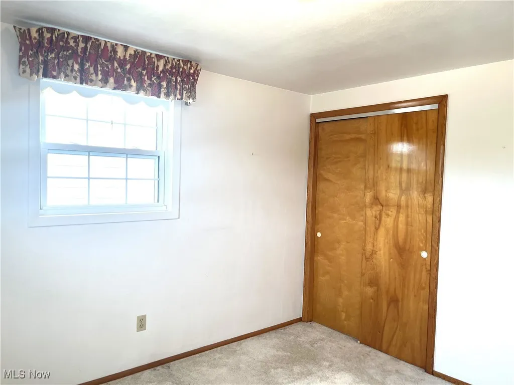 Unfurnished bedroom with a closet and carpet
