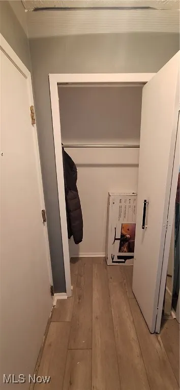 Laundry area with light wood-style flooring