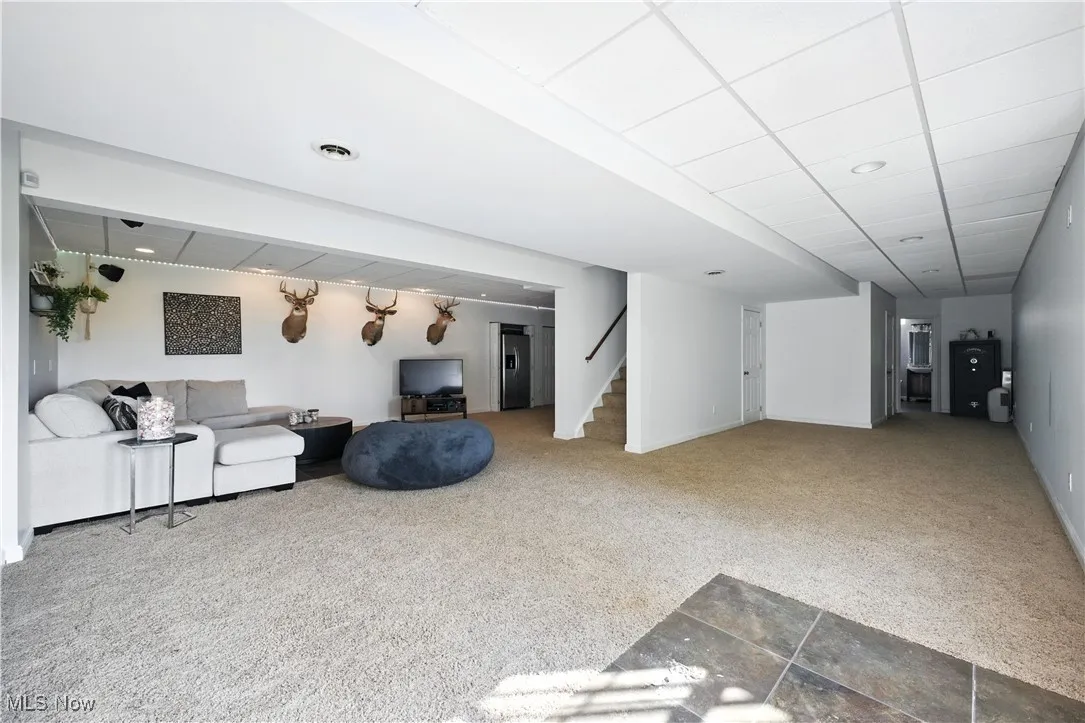 Living room featuring carpet floors and stairs