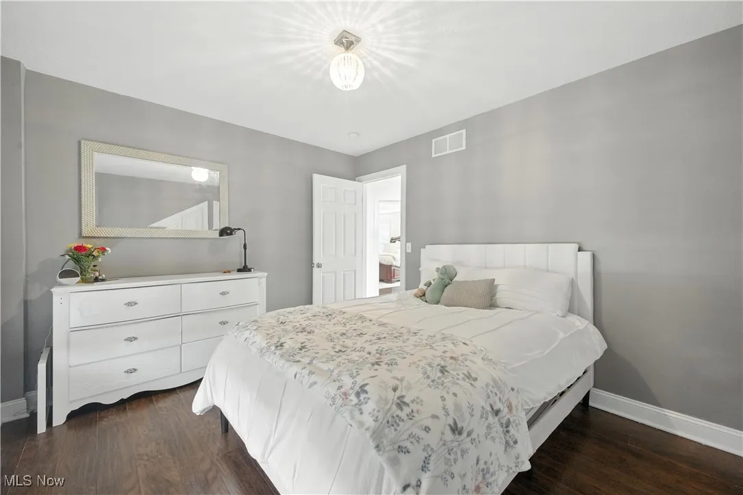 Bedroom featuring baseboards and dark wood-style flooring