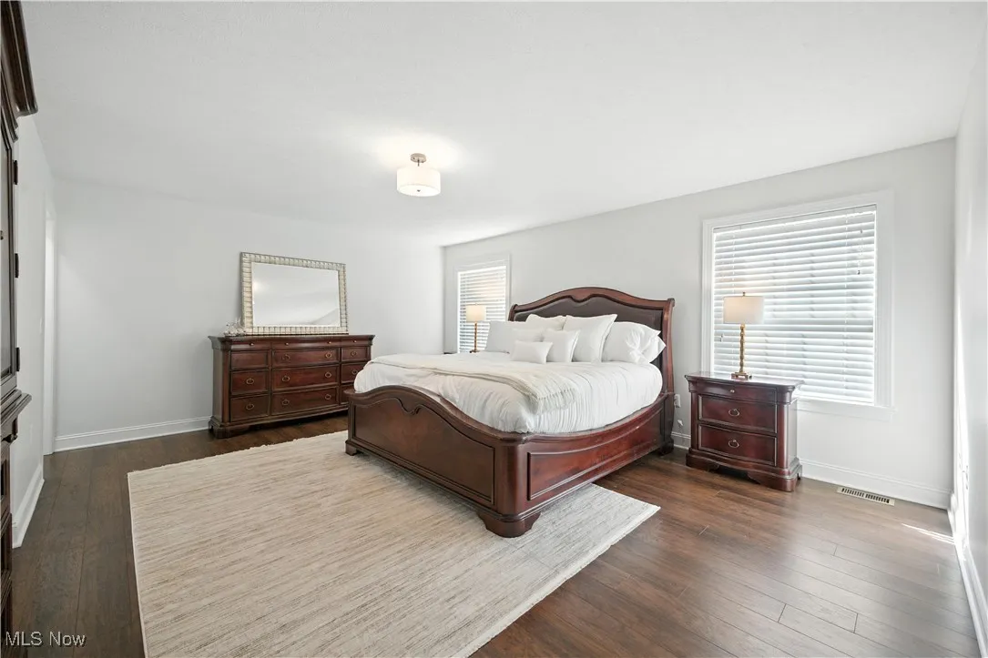 Bedroom with baseboards and dark wood-style floors