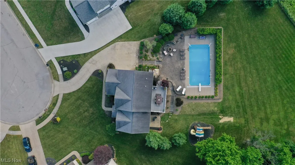 Aerial view of property and surrounding area featuring a pool
