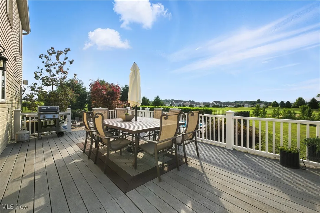 Deck featuring outdoor dining space and a grill