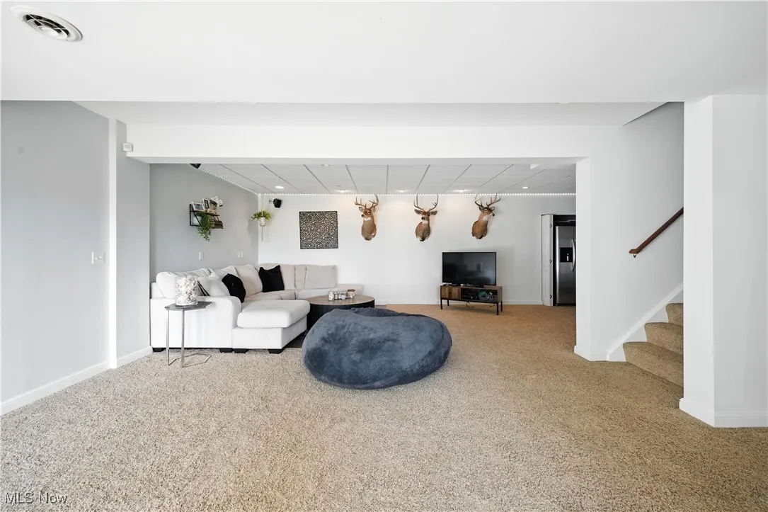 Living room with carpet and stairs