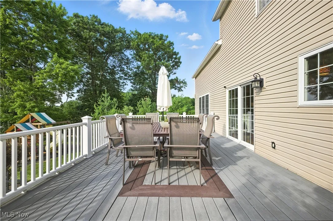 Deck with outdoor dining area and a playground