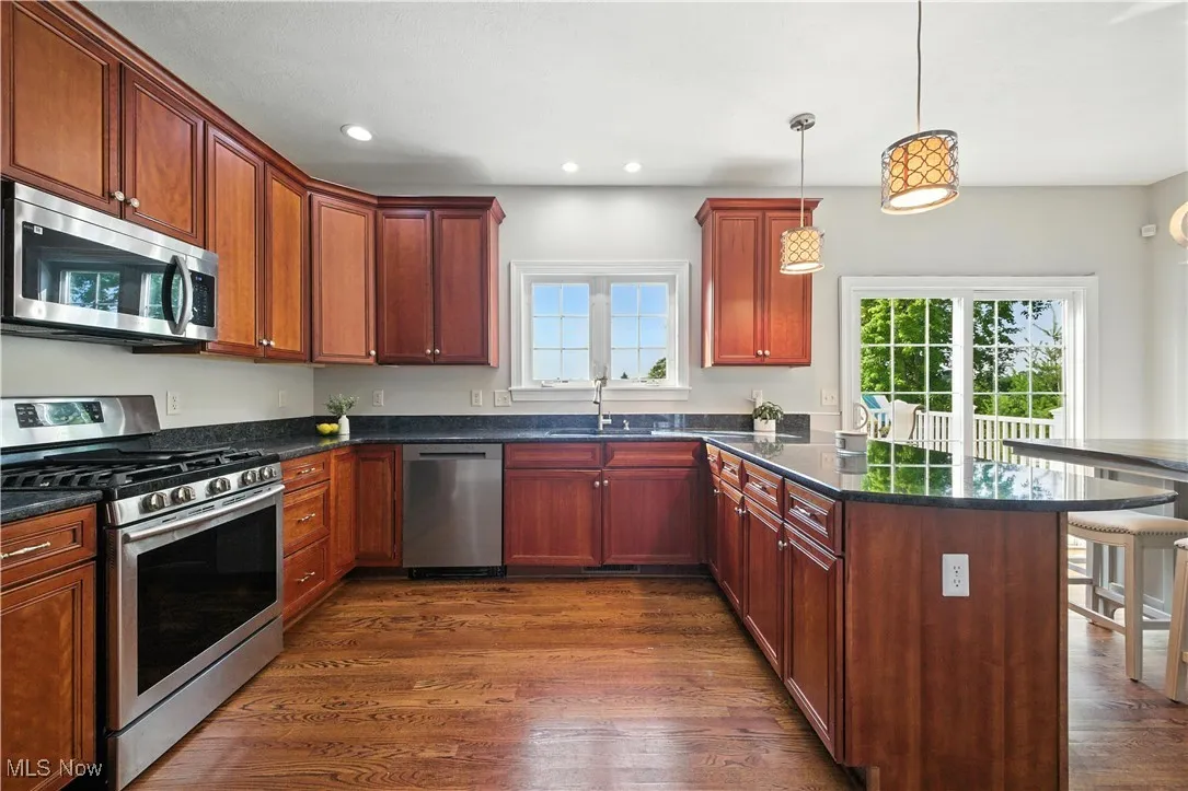 Kitchen with stainless steel appliances, a breakfast bar area, plenty of natural light, a peninsula, and recessed lighting