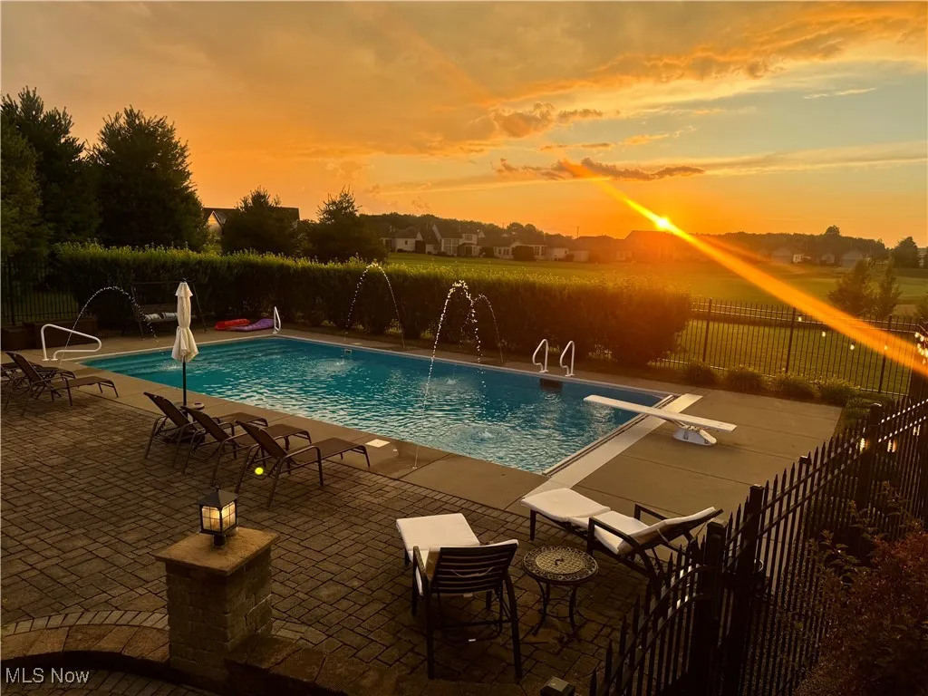 View of swimming pool featuring a patio area and a diving​​‌​​​​‌​​‌‌​‌‌​​​‌‌​‌​‌​‌​​​‌​​ board