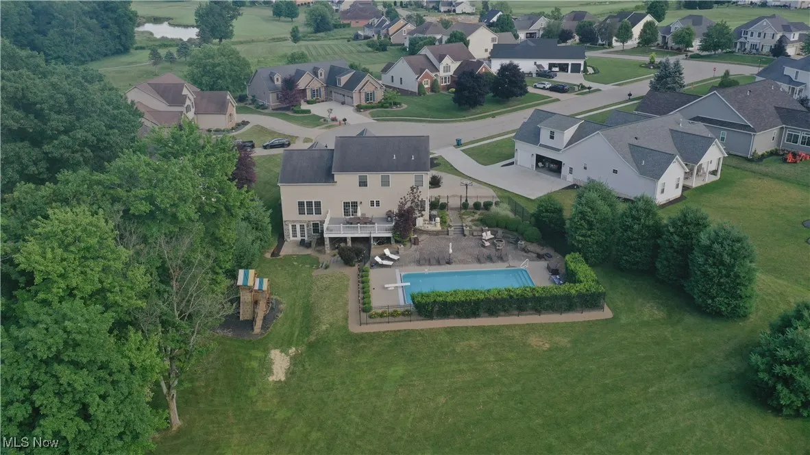 Aerial perspective of suburban area featuring a pool