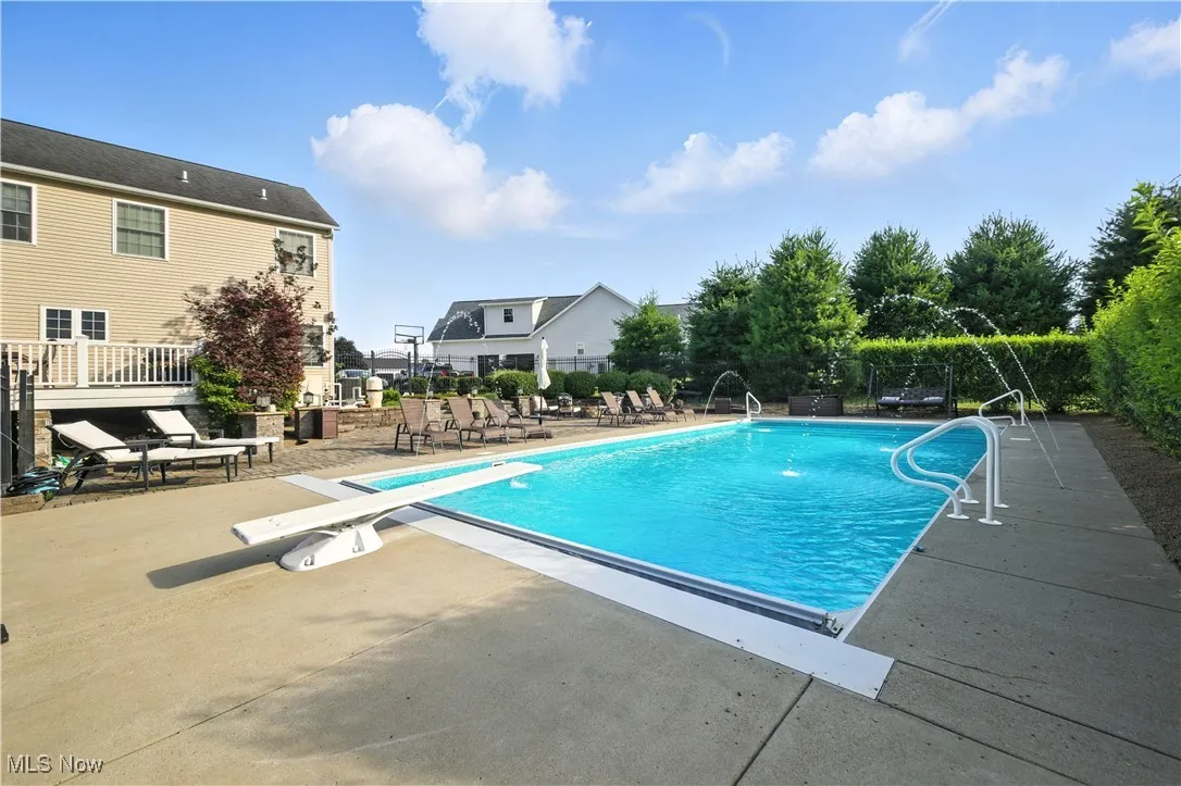 View of pool featuring a patio area and a diving board