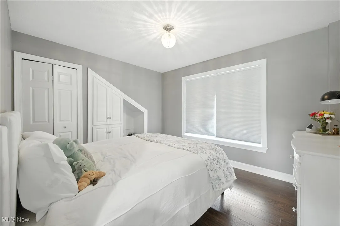 Bedroom with baseboards and dark wood finished floors