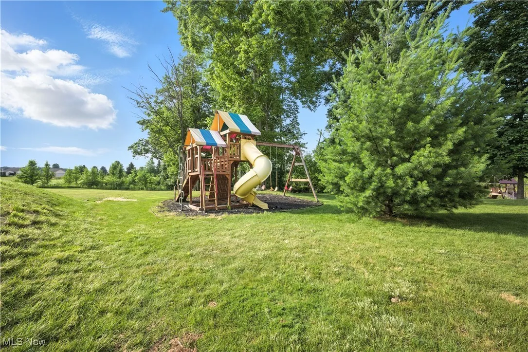 View of play area featuring a lawn