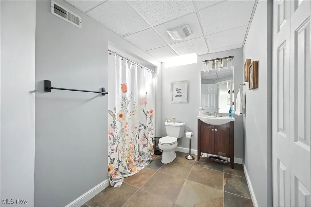 Full bath with vanity, a paneled ceiling, and a shower with curtain