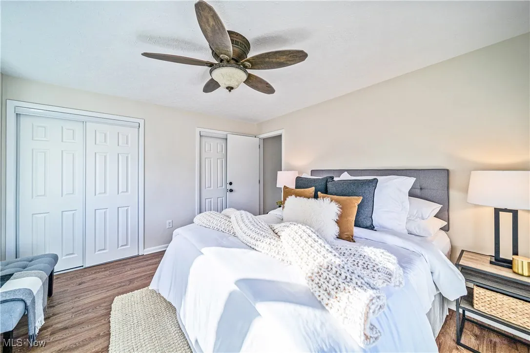 Bedroom featuring ceiling fan and dark hardwood / wood-style floors