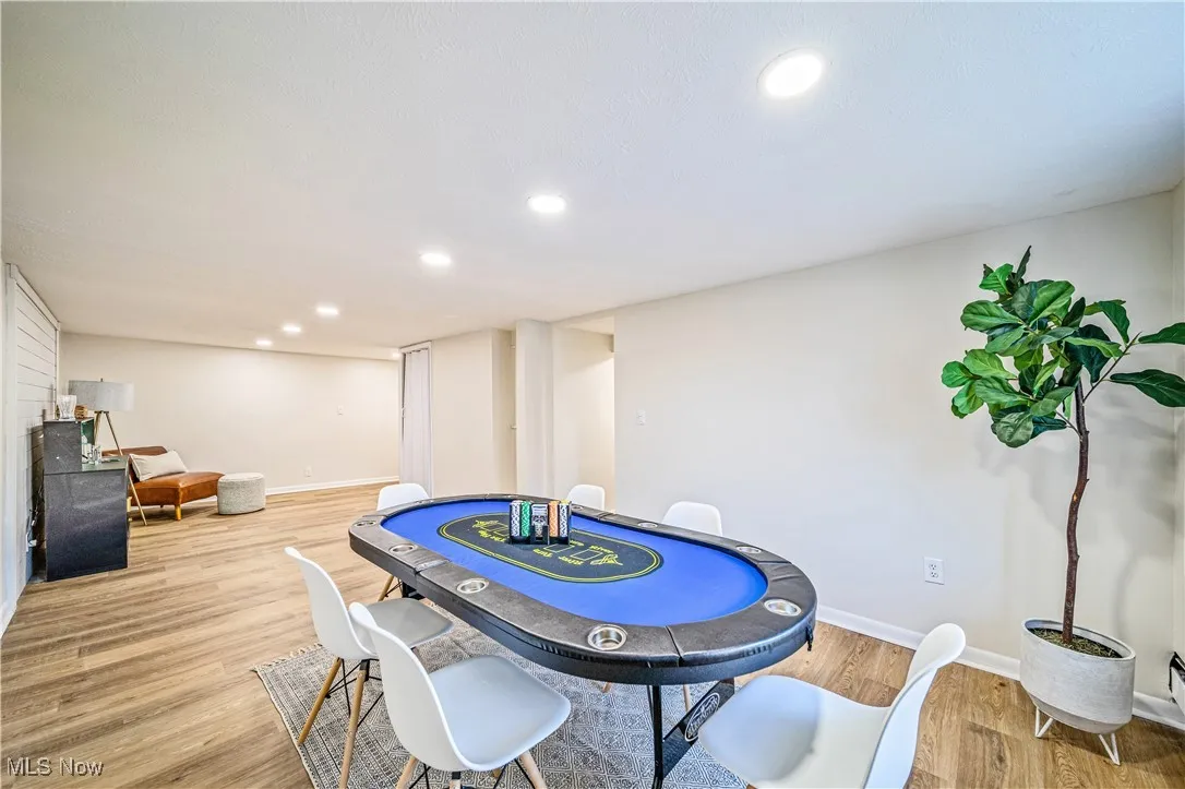 Game room with light hardwood / wood-style floors