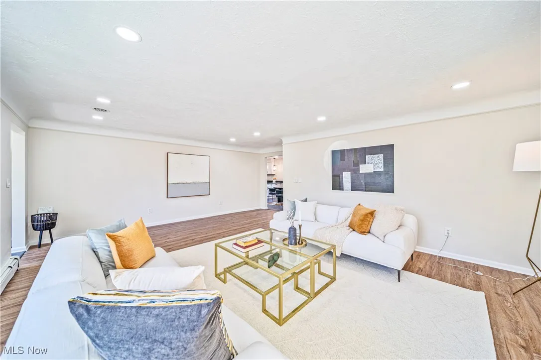 Living room featuring wood-type flooring and a textured ceiling