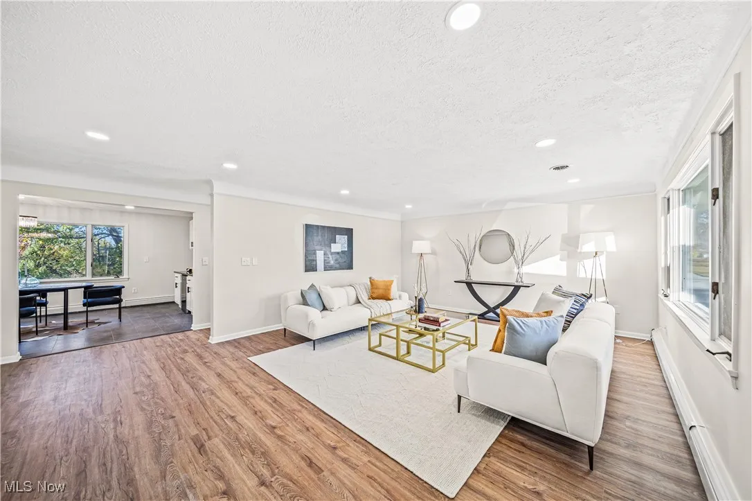 Living room with wood-type flooring and a textured ceiling