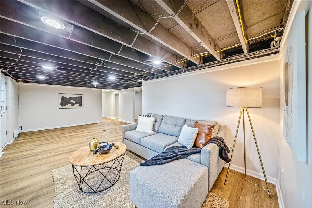 Living room with hardwood / wood-style flooring and a baseboard radiator