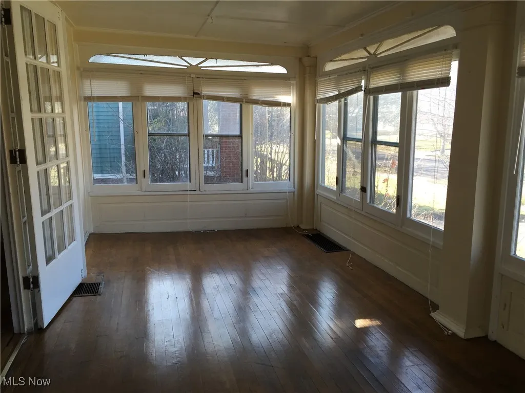 Unfurnished sunroom featuring hardwood / wood-style flooring