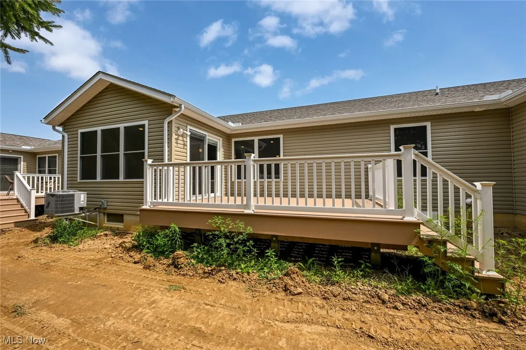 Rear view of property featuring a deck.