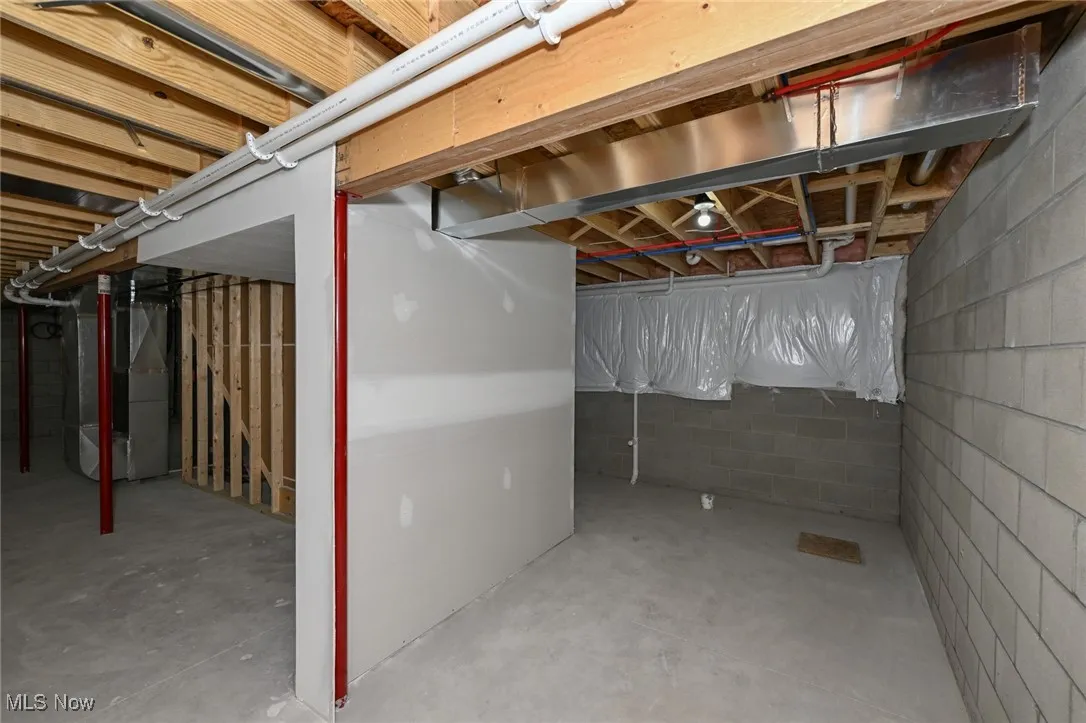 Unfinished below grade area featuring heating unit