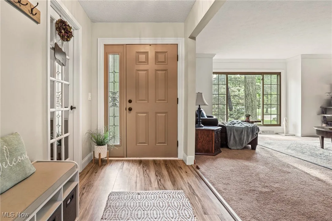 Foyer entrance featuring wood finished floors and a textured ceiling