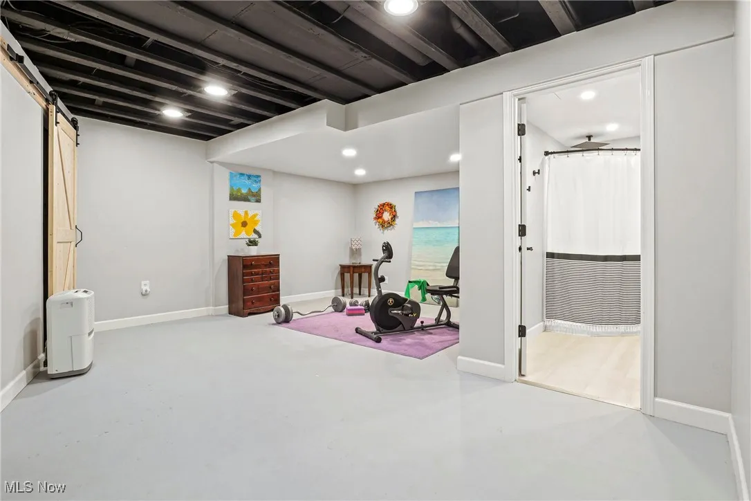 Basement with recessed lighting and a barn door