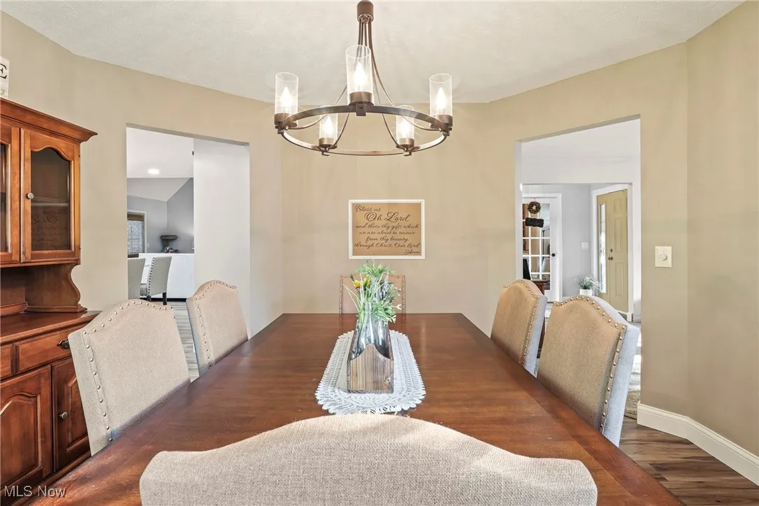 Dining space featuring a chandelier and dark wood-style floors