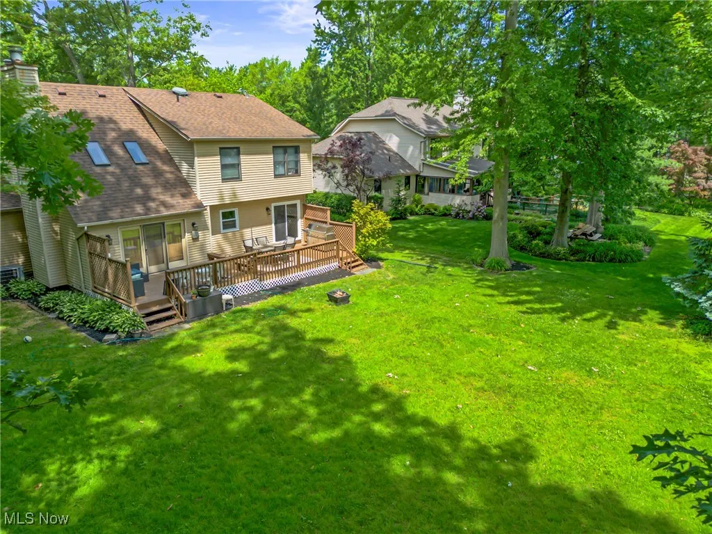 View of grassy yard with a deck