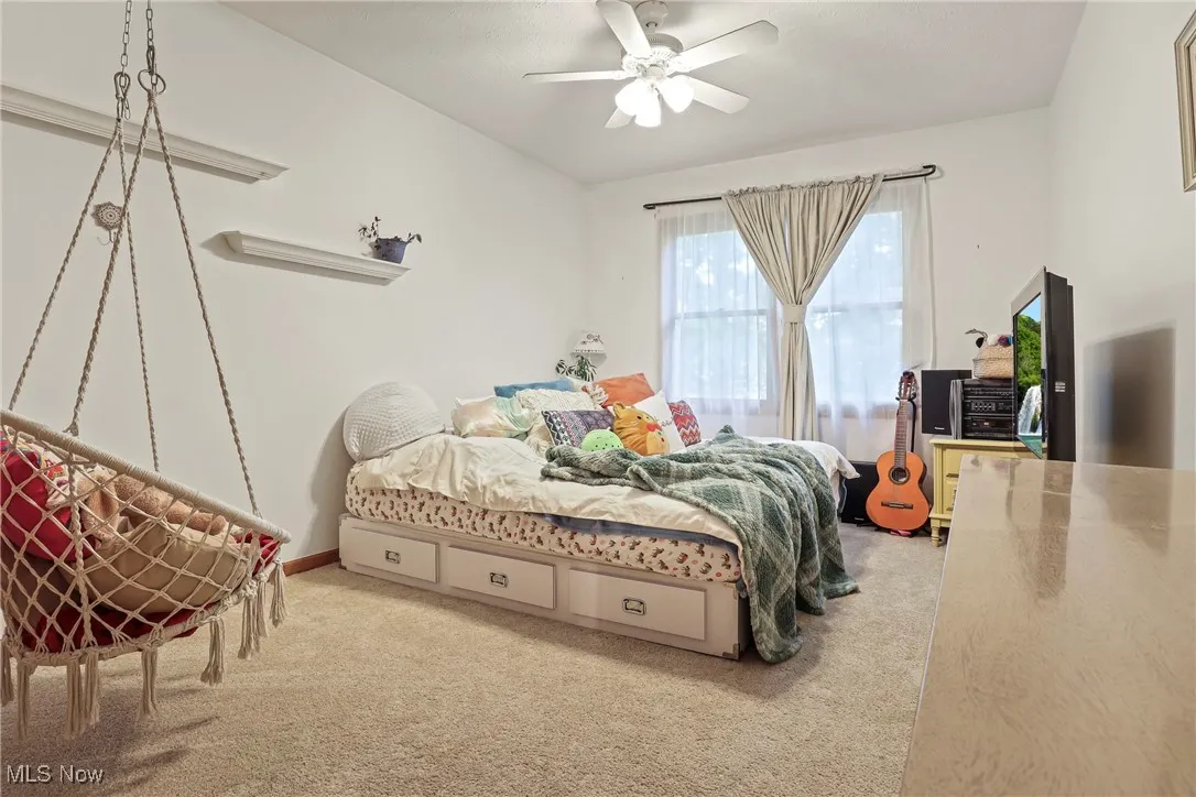 Bedroom with carpet flooring and a ceiling fan