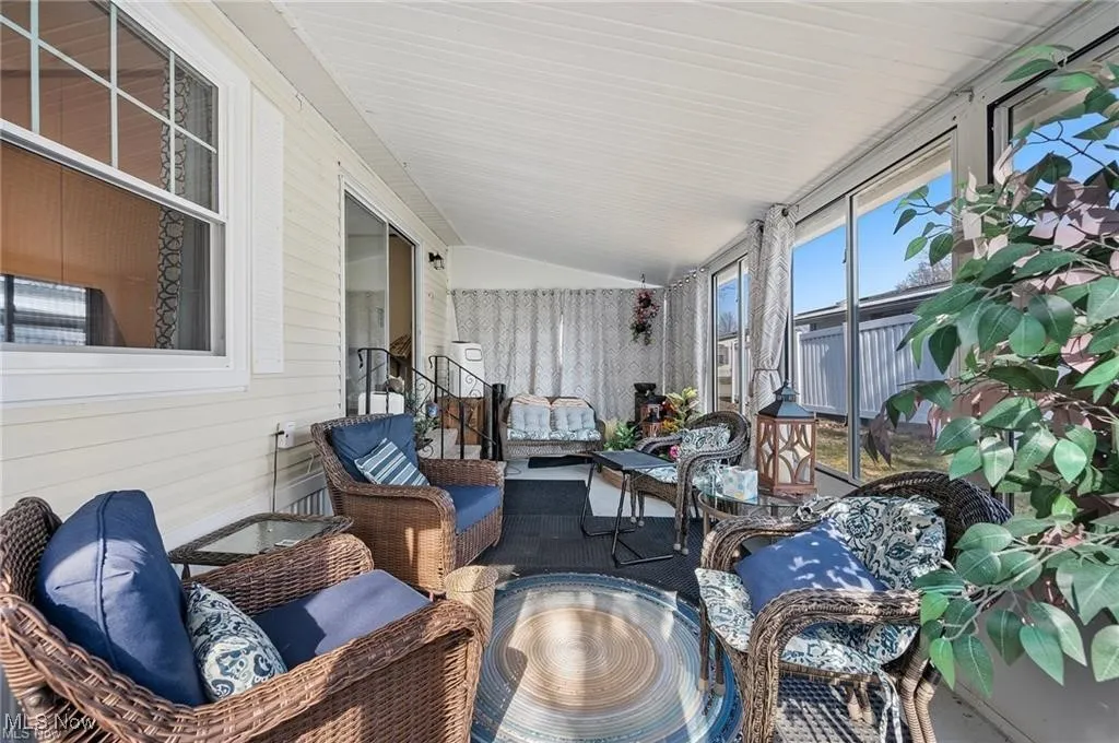 Sunroom with vaulted ceiling and an outdoor hangout area