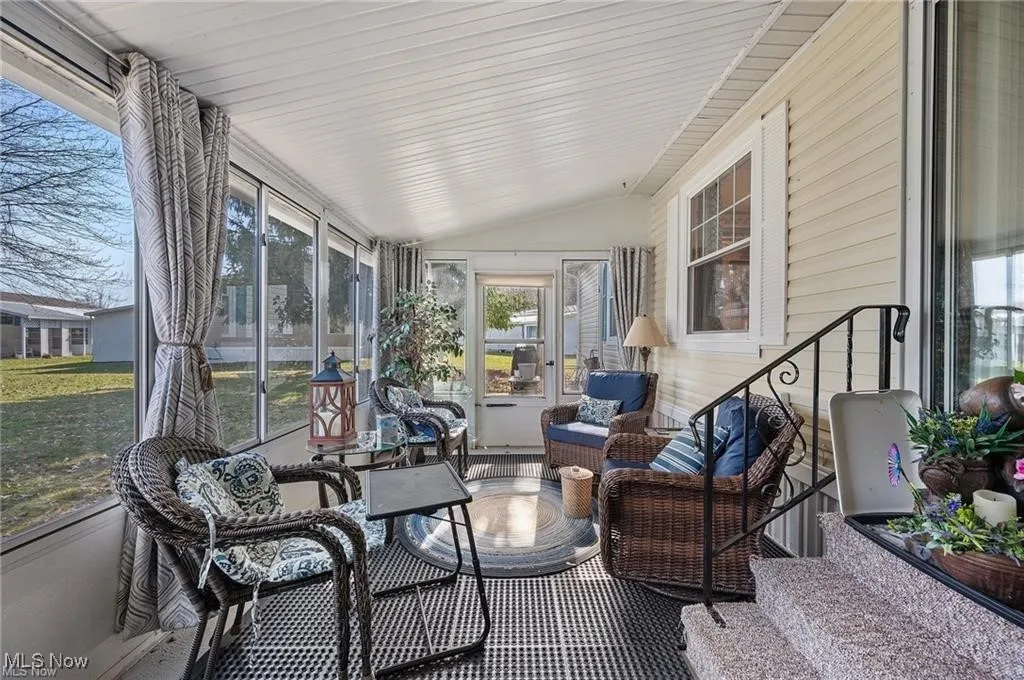 Sunroom / solarium featuring vaulted ceiling
